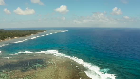 The Coast of Siargao Island, Blue Ocean and Waves.