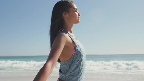 Mixed race woman enjoying the fresh air at beach