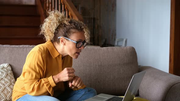 Happy adult woman receive notification on laptop computer and celebrate with joy - female people