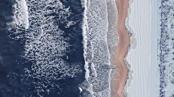 Tourism in Poland. Snowy beach and Baltic sea in winter