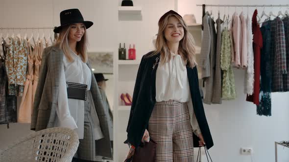 Satisfied Young Customers Leaving Modern Fashion Store After Shopping