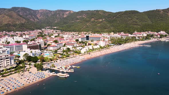 Drone flight over the resort town and hotels against the backdrop of the Mediterranean sea blue sky