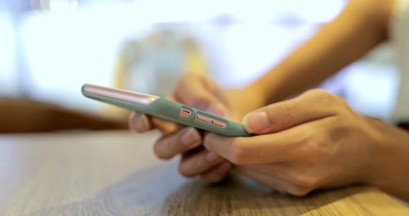 Woman typing on mobile phone at outdoor 