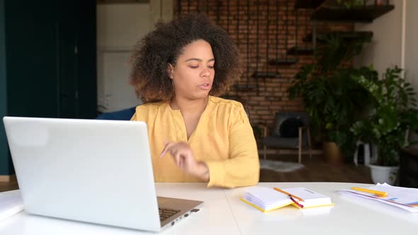 Smart and Clever Focused AfricanAmerican Female Student Using Laptop