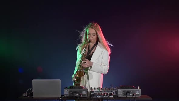 Young Sexy, Blonde Woman Dj Playing Music Using Saxophone on Black, Slow Motion