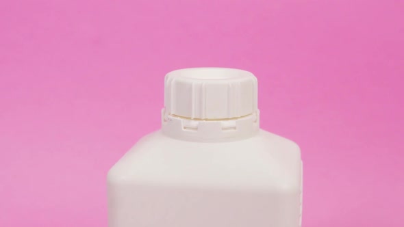 Closeup of a Round Stopper the Lid on a Square Bottle with Household Chemicals