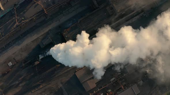 Industrial Zone with a Large Red and White Pipe Thick White Smoke Is Poured From the Factory Pipe in