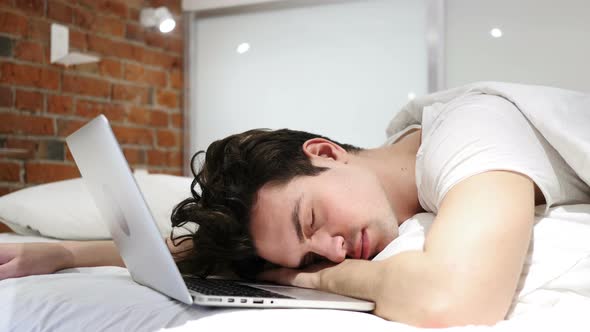 Man Sleeping in Bed near Laptop, After Work