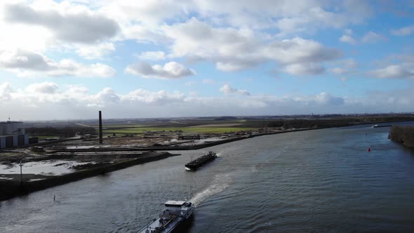 Aerial View Of Barge Ships Transporting Goods By River Oude Maas Near Puttershoek, South Holland, Ne