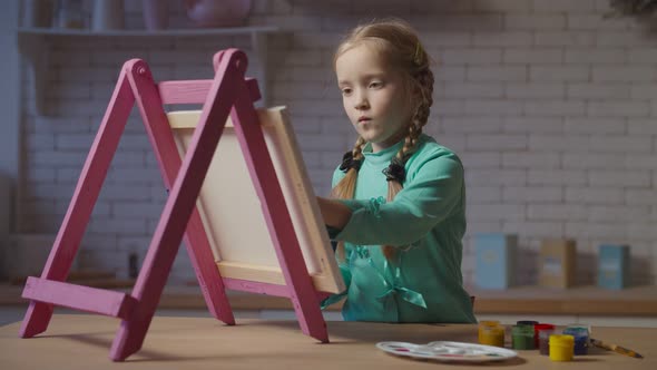 Little Girl Painting with Hands Painted on Easel