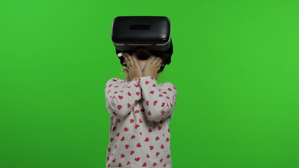 Child Girl Using VR Headset Helmet To Play Game. Watching Virtual Reality 3d 360 Video. Chroma Key