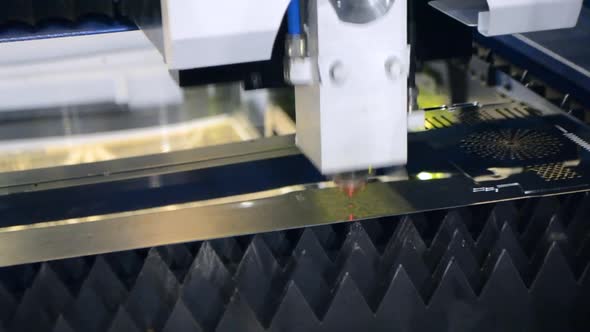 A Laser Beam Cuts the Sheet Metal in the Manufacture