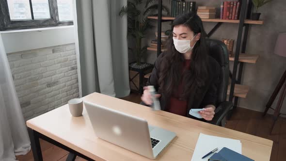 Young Woman Cleaning and Disinfection Her Workspace. Disinfecting Wipes To Wipe Surface of Desk