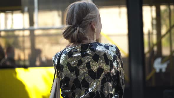 Back View Cheerful Young Caucasian Woman Waving Goodbye to Yellow Bus Passing Sending Air Kiss