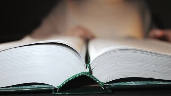 Student Woman Closes Thick Book After Reading