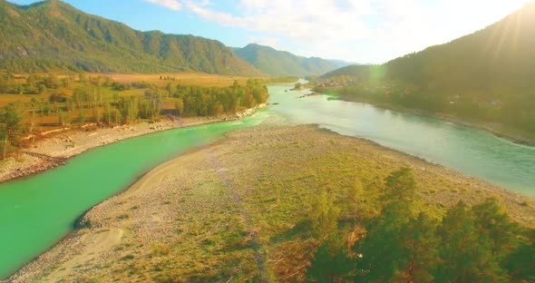 Low Altitude Flight Over Fresh Fast Mountain River with Rocks at Sunny Summer Morning.