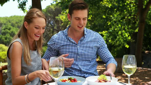 Couple having food in outdoor restaurant 4k