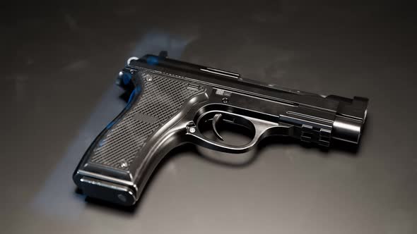 Gun with fingerprints in UV light. Biometric identification in ultraviolet rays