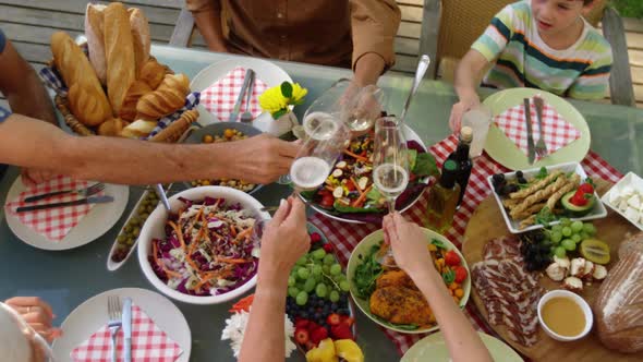 Family eating outside together in summer