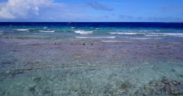 Luxury overhead tourism shot of a white sandy paradise beach and blue ocean background in colourful 