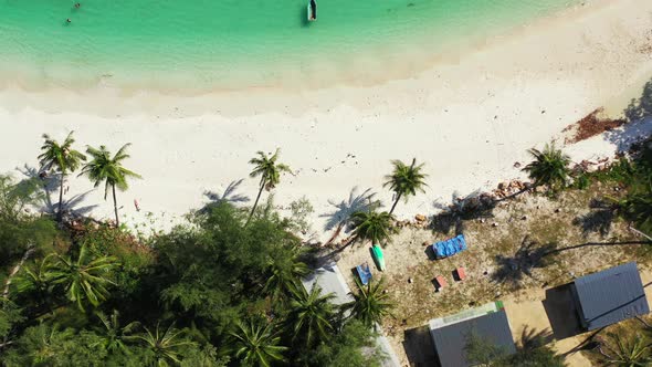 Tropical overhead copy space shot of a white sandy paradise beach and turquoise sea background 