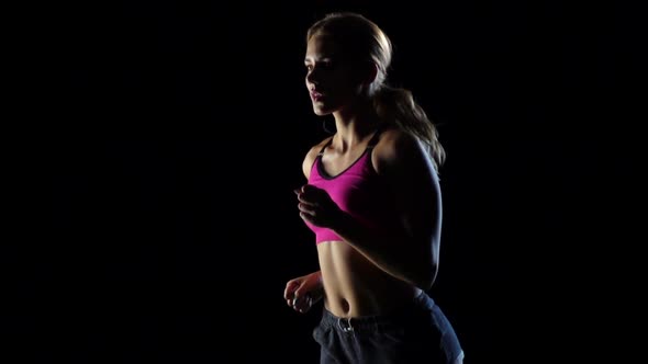 Wonderful Lass Is Running on a Black Background. Slow Motion