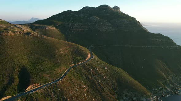 mountain panoramic of Chapmans Peak coast during sunset in Cape Town, aerial
