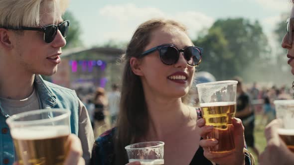 Group of friends spending time together at music festival and drinking beer. Shot with RED helium ca