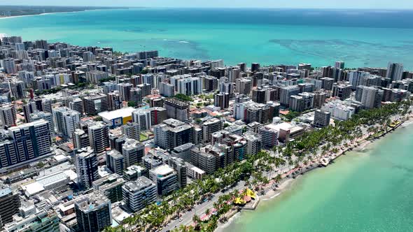 Aerial panning shot of turquoise water beach at Maceio Alagoas Brazil. 