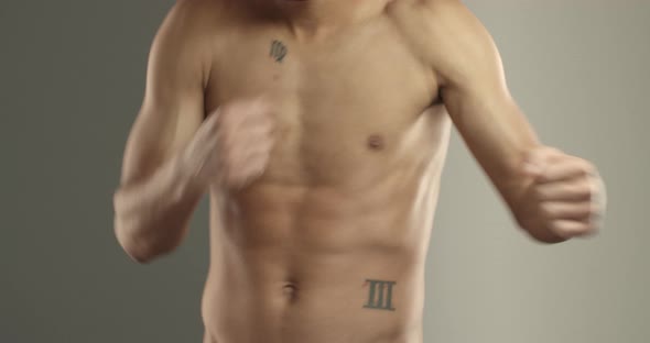 Closeup of Sportsman Bare Torso with Abs Boxer Chest and Hands Athlete Do Shadowboxing Exercises