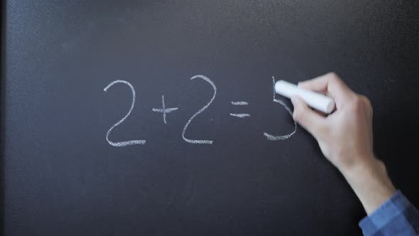 Doing sums on chalkboard. 2+2=5