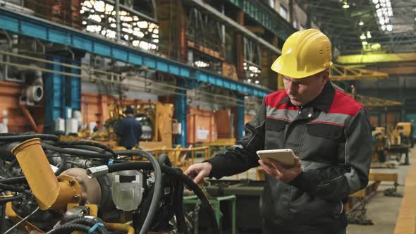 Plant Engineer Inspecting Machinery In Assembly Shop / Videohive