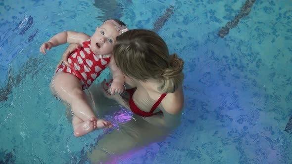 Little Girl with Her Mother in the Swimming Pool