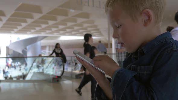 Child Looking Through the Photos on Smart Phone