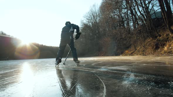 MOSCOW RUSSIA 10 DECEMBER 2019 Hockey Player on Frozen Lake Make Ice Sparkles on High Speed Braking