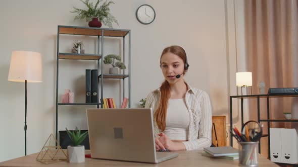 Woman with Headset Using Laptop Talking Working Customer Support Service Operator at Home Office