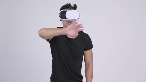 Young Handsome Multi-ethnic Man Using Virtual Reality Headset