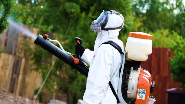  Exterminator processing a tree in white suit