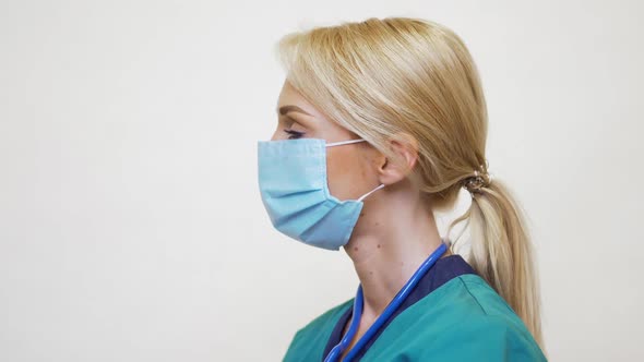 Medical Doctor Nurse Woman with Stethoscope Wearing Protective Mask and Rubber or Latex Gloves