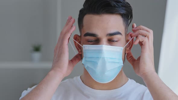 Portrait of Arabic Man Patient Guy in White Tshirt Takes Off Blue Protective Medical Mask From Face