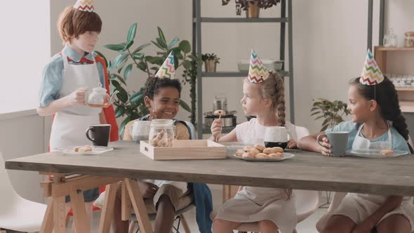 Diverse Kids Having Tea with Cookies