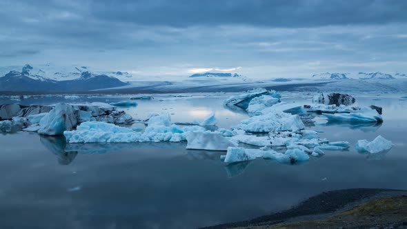 Blue Icebergs Floating Under Midnight Sun