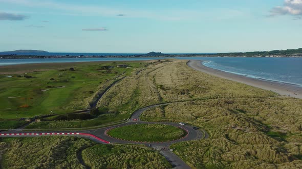 Drone flying backward, over the Irish landscape at golden hour