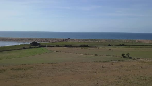 Aerial tracking and rotating from right to left looking across the fleet lagoon and Chesil Beach, Do