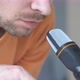 Bearded man making ASMR sounds with microphone eating chips. - VideoHive Item for Sale