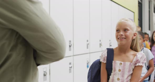 Video of happy video of teacher and happy diverse pupils waiting for entering classroom