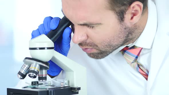 Scientist Using Microscope in Laboratory