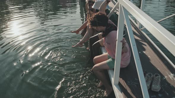 Friends Getting their Feet Wet in Lake