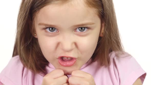 Child Is Angry, She Is Very Nervous. . White Background. Close Up