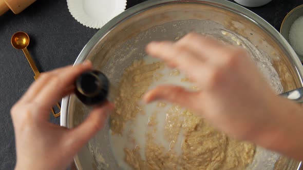 Hands Making Batter with Milk at Bakery